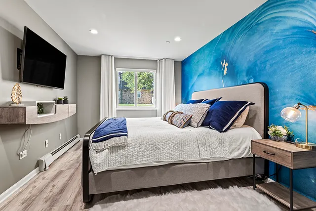 a bed room with a bed window and a television