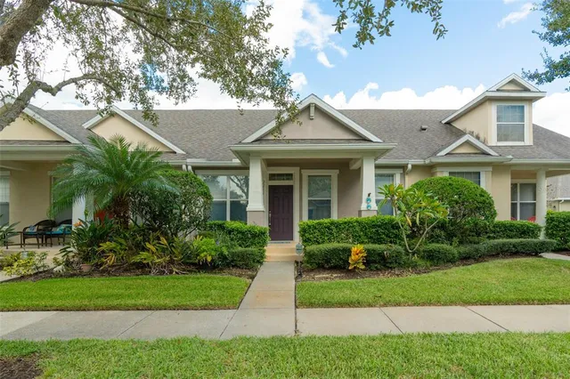 a front view of a house with a yard and potted plants