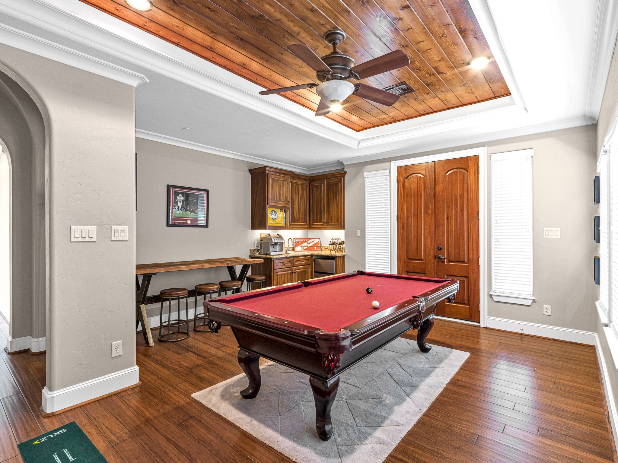 4614 Inker Street Houston, TX 77007 - Photo 30 of 36 This inviting game room features a wood ceiling with recessed lighting, space for a pool table, a small bar area, and a door leading to a balcony overlooking the front of the home.