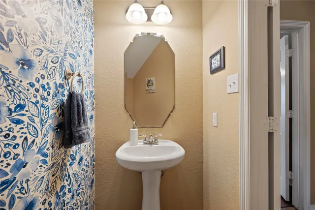 a bathroom with a sink and mirror