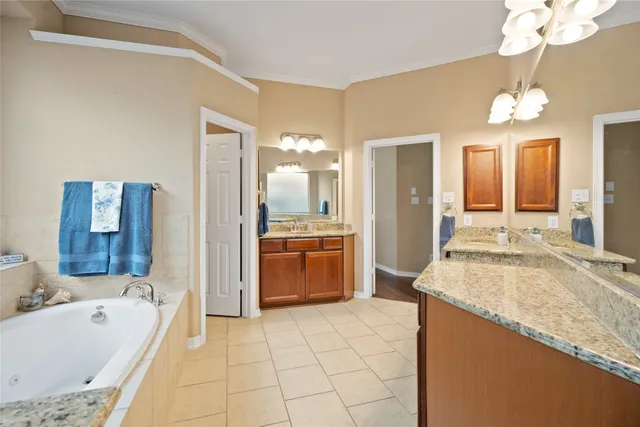a spacious bathroom with a granite countertop sink a toilet a mirror and bathtub