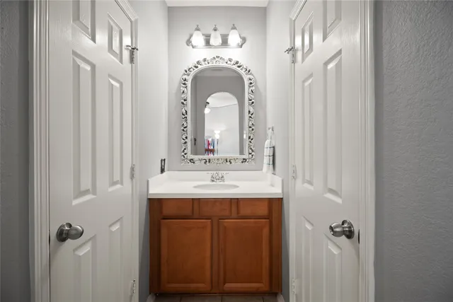 a bathroom with a sink mirror and vanity
