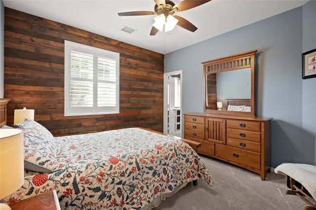 a bedroom with a bed and a dresser