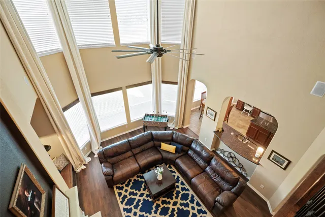 a living room with furniture and a floor to ceiling window