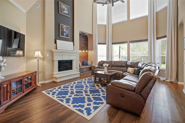 a living room with furniture fireplace and flat screen tv