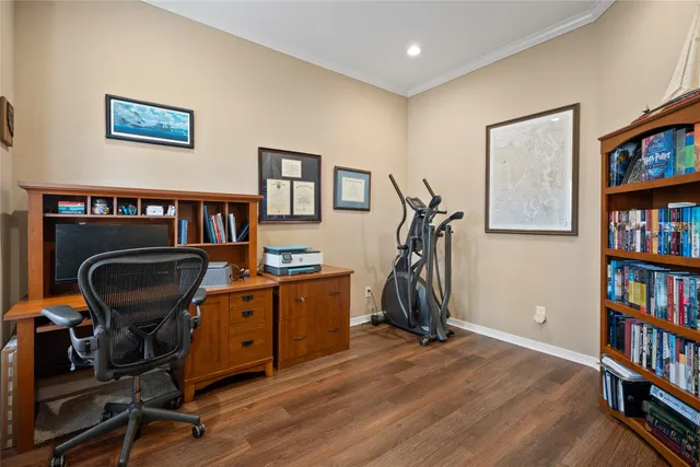 a view of a workspace with furniture and book shelf