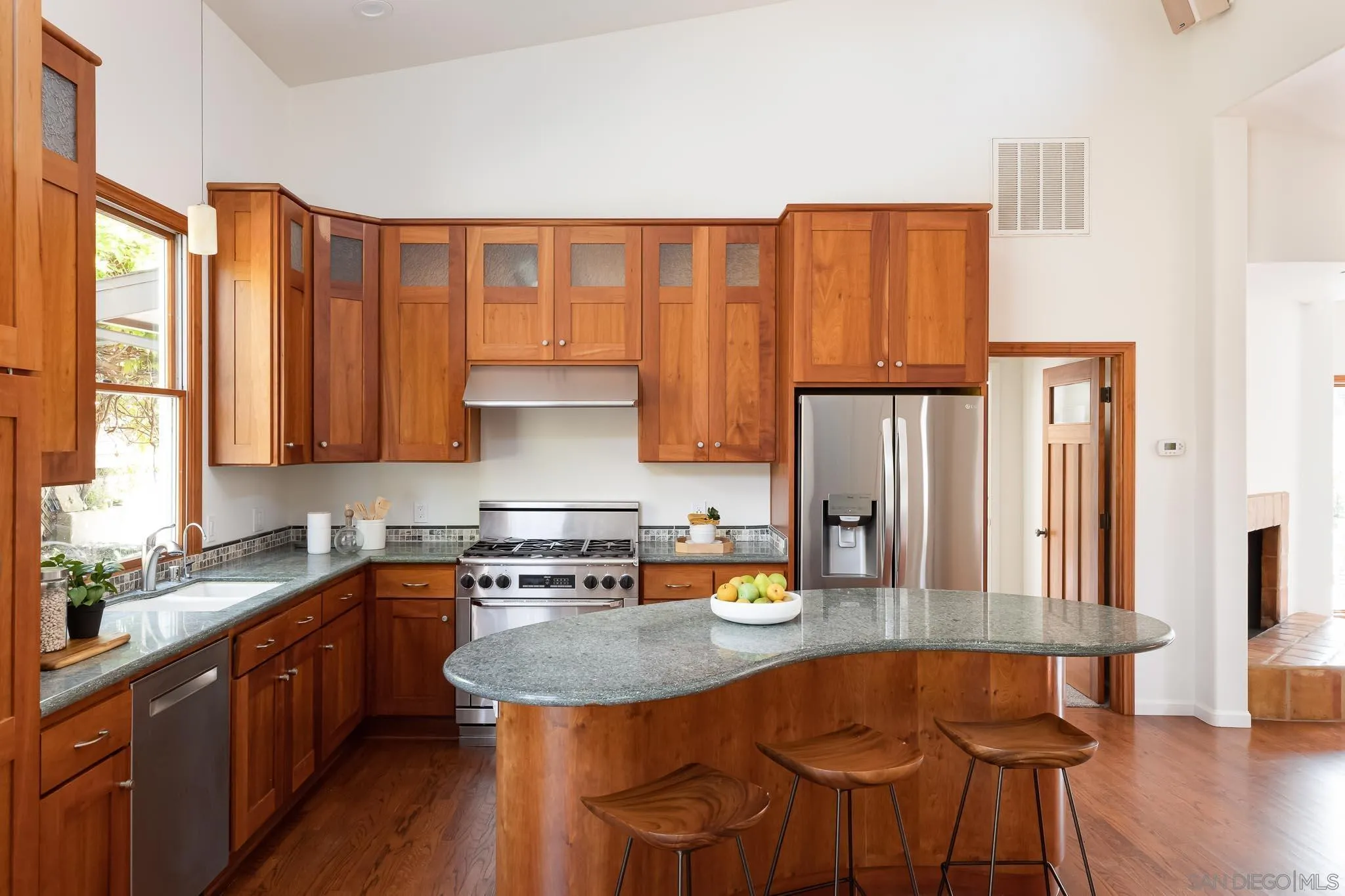 1496 Hymettus Avenue Encinitas, CA 92024 - Photo 11 of 53 a kitchen with stainless steel appliances granite countertop a stove a sink dishwasher and cabinets with wooden floor