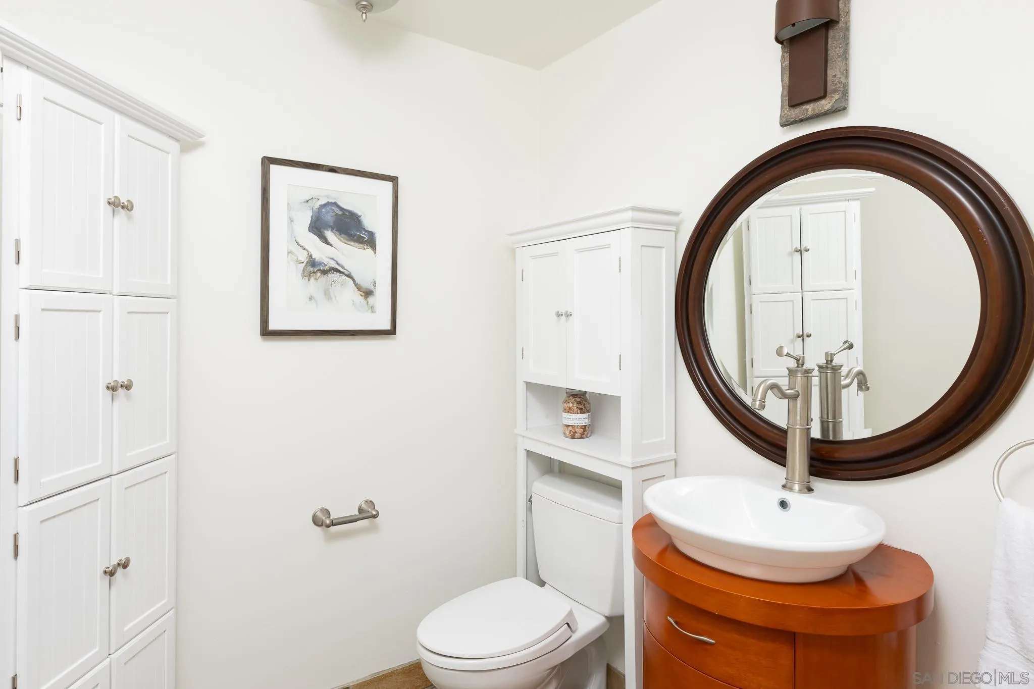 1496 Hymettus Avenue Encinitas, CA 92024 - Photo 20 of 53 a bathroom with a toilet a sink and a mirror