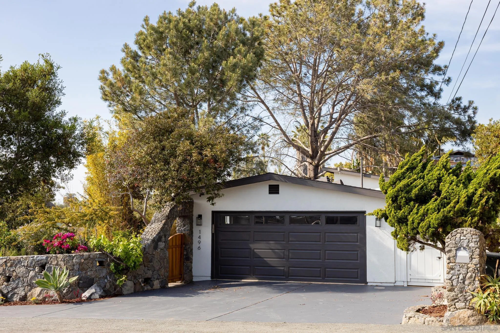 1496 Hymettus Avenue Encinitas, CA 92024 - Photo 2 of 53 a front view of a house with a garage