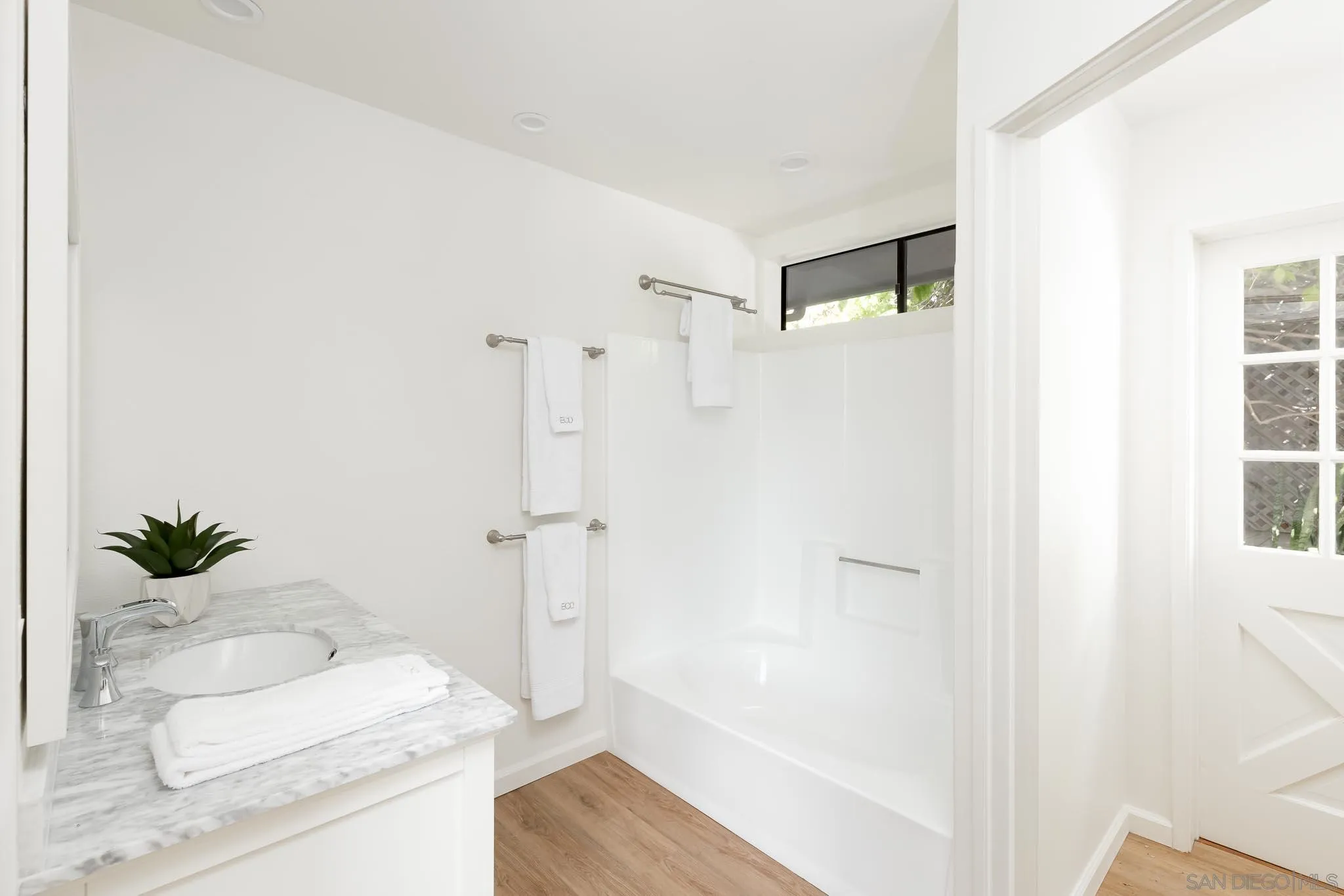 1496 Hymettus Avenue Encinitas, CA 92024 - Photo 21 of 53 a bathroom with a shower curtain and a sink