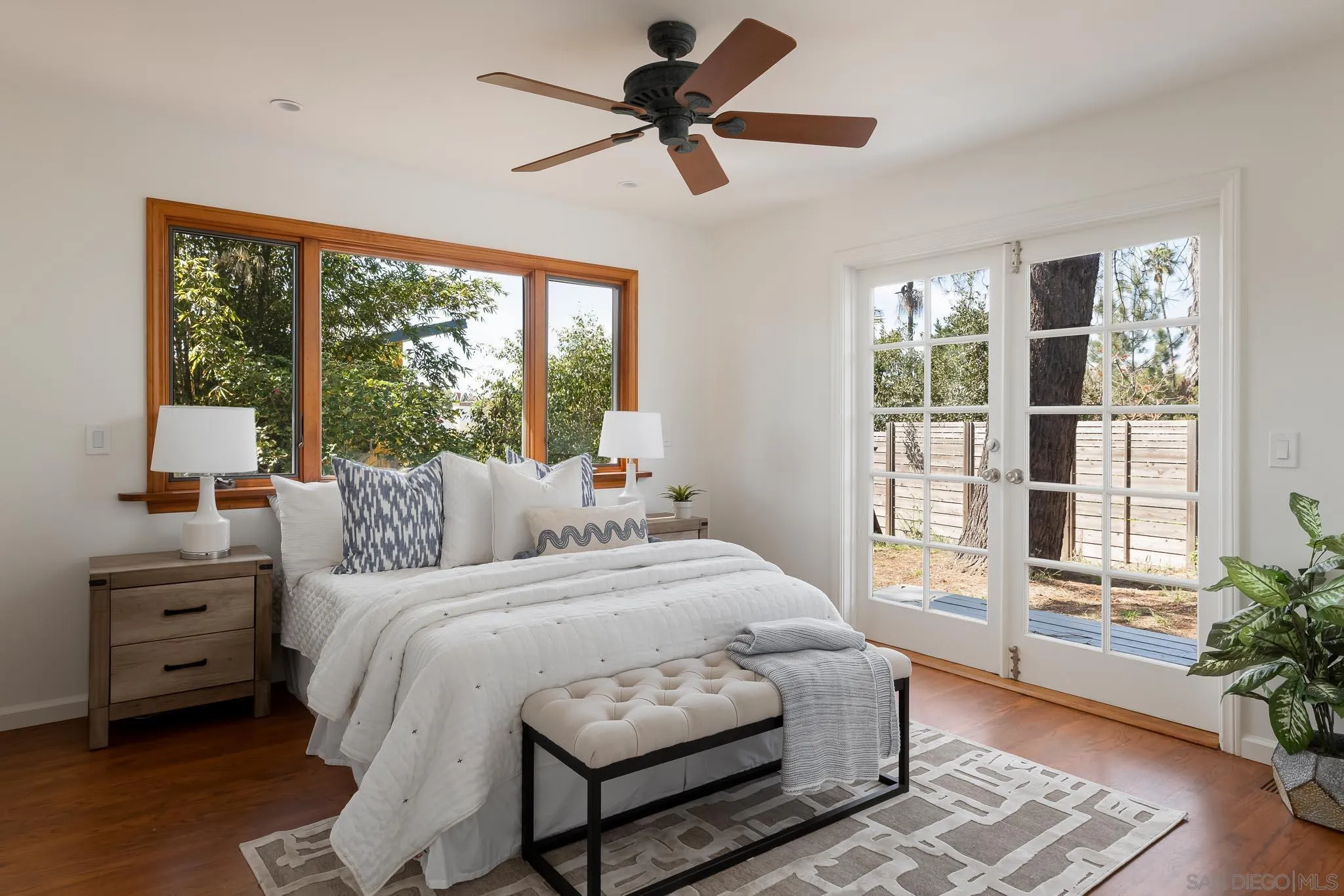 1496 Hymettus Avenue Encinitas, CA 92024 - Photo 28 of 53 a bedroom with a bed a chandelier and a large window