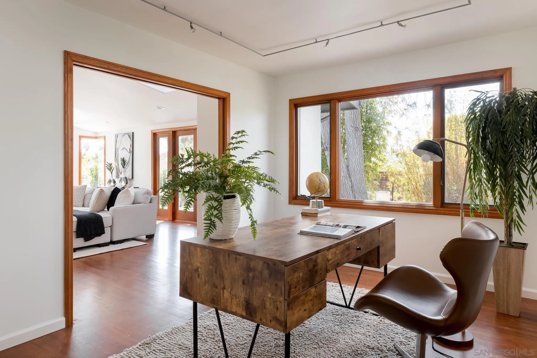 1496 Hymettus Avenue Encinitas, CA 92024 - Photo 37 of 53 a view of a workspace with furniture and a potted plant