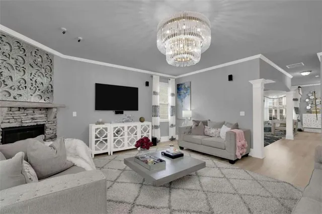 a living room with furniture a flat screen tv and a fireplace