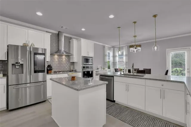 a kitchen with stainless steel appliances a sink stove and refrigerator