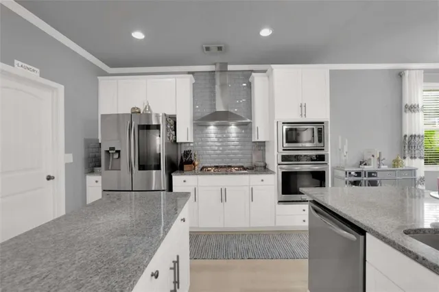 a kitchen with refrigerator and cabinets