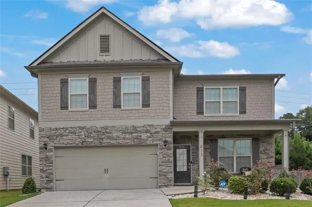 a front view of a house with garden