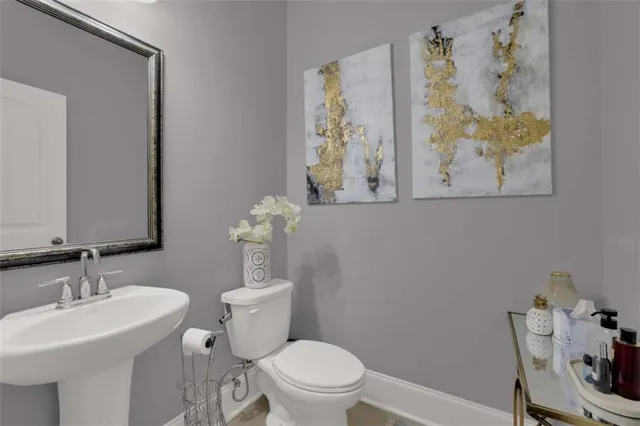 a bathroom with a toilet a sink and a mirror