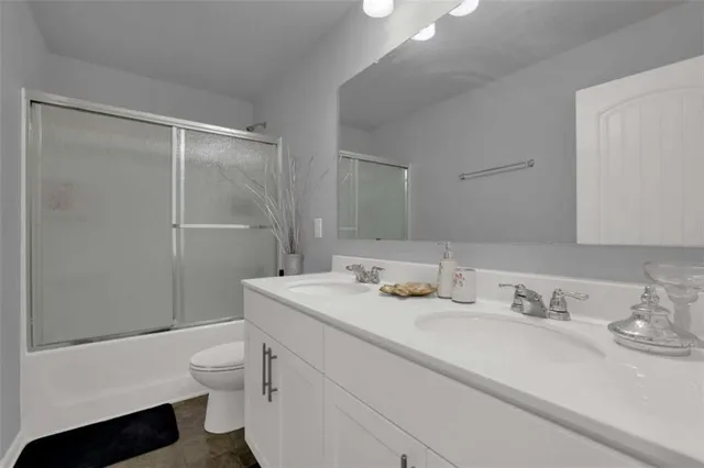 a bathroom with a sink toilet vanity and shower