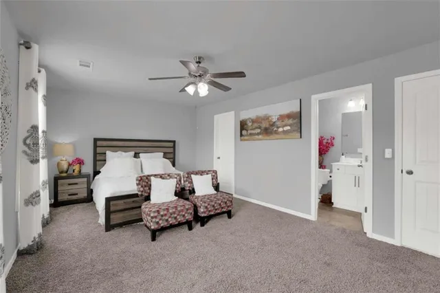 a bathroom with a sink vanity mirror and toilet