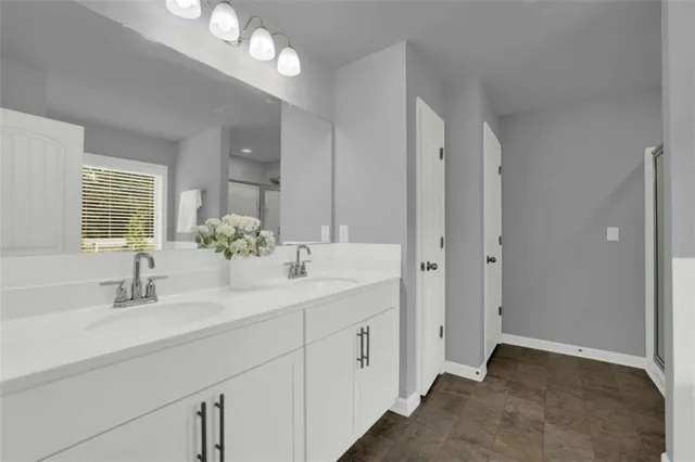 a bathroom with double sink and a mirror