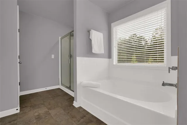 an aerial view of a house with a yard and large trees