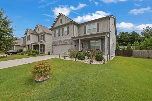 a front view of a house with garden