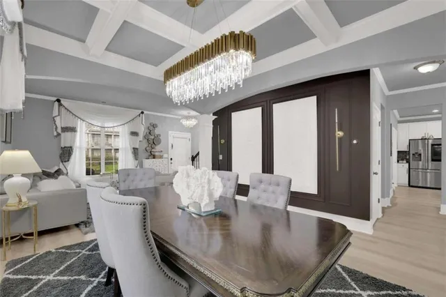 a dining room with furniture a chandelier and wooden floor