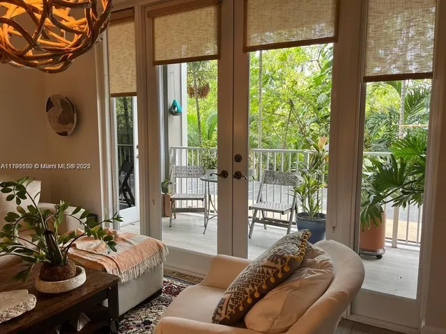 a living room with furniture and a floor to ceiling window