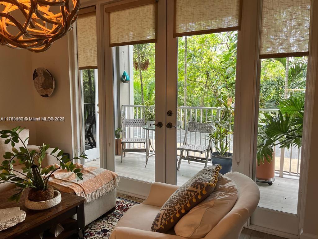 3540 Main Highway, Unit 204 Miami, FL 33133 - Photo 3 of 9 a living room with furniture and a floor to ceiling window
