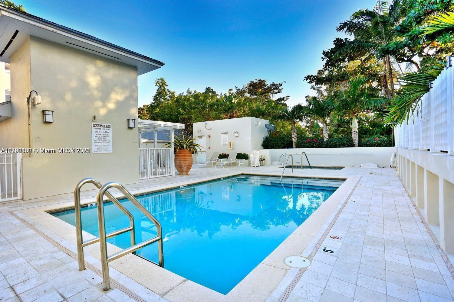3540 Main Highway, Unit 204 Miami, FL 33133 - Photo 8 of 9 a view of a swimming pool with a patio