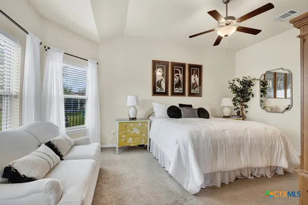 a bedroom with a large bed and a window