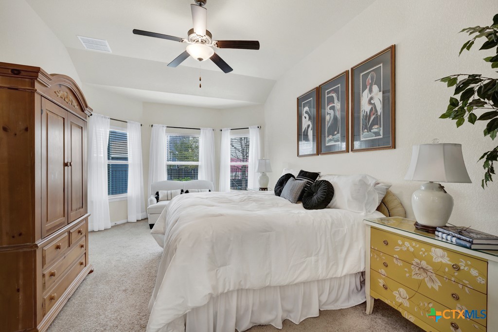 1444 Harwell Loop Kyle, TX 78640 - Photo 15 of 37 a bedroom with a large bed and a window