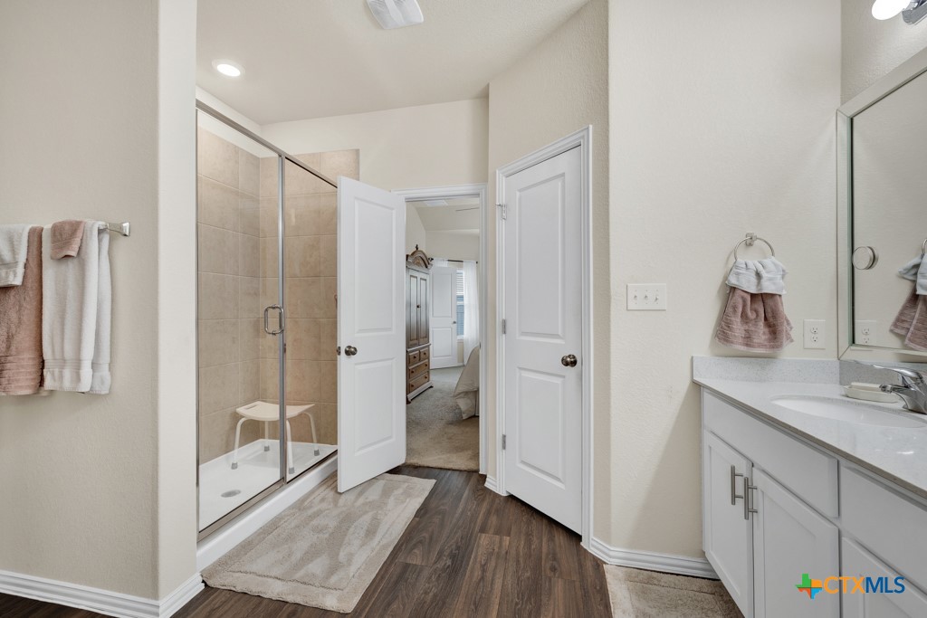 1444 Harwell Loop Kyle, TX 78640 - Photo 16 of 37 a bathroom with a sink and a mirror