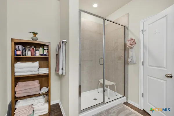 a spacious bathroom with a double vanity sink and a mirror