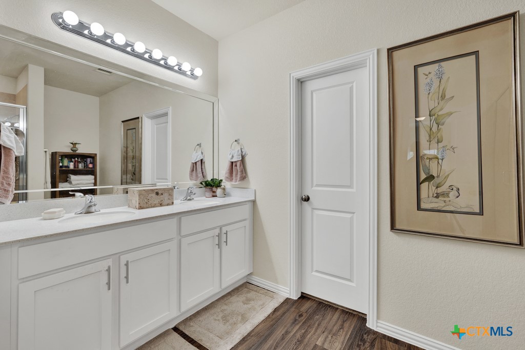 1444 Harwell Loop Kyle, TX 78640 - Photo 18 of 37 a spacious bathroom with a double vanity sink and a mirror