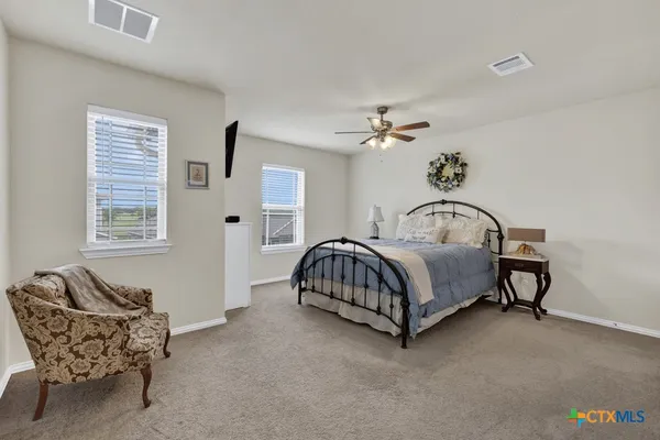 a bedroom with a bed and a couch
