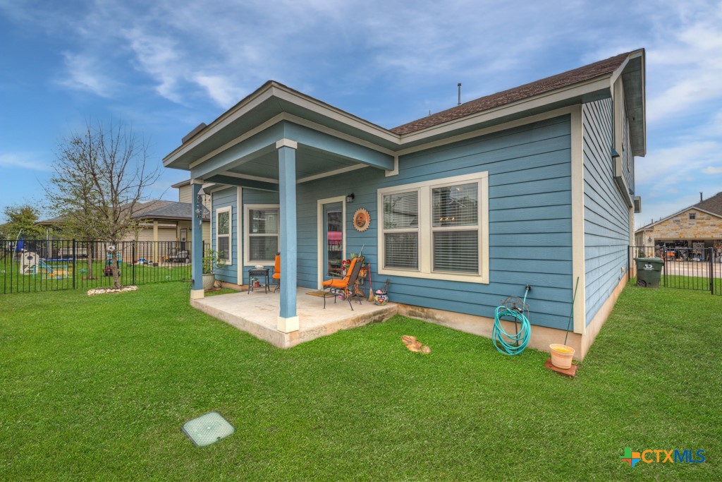 1444 Harwell Loop Kyle, TX 78640 - Photo 29 of 37 a front view of a house with a yard glass top table and chairs