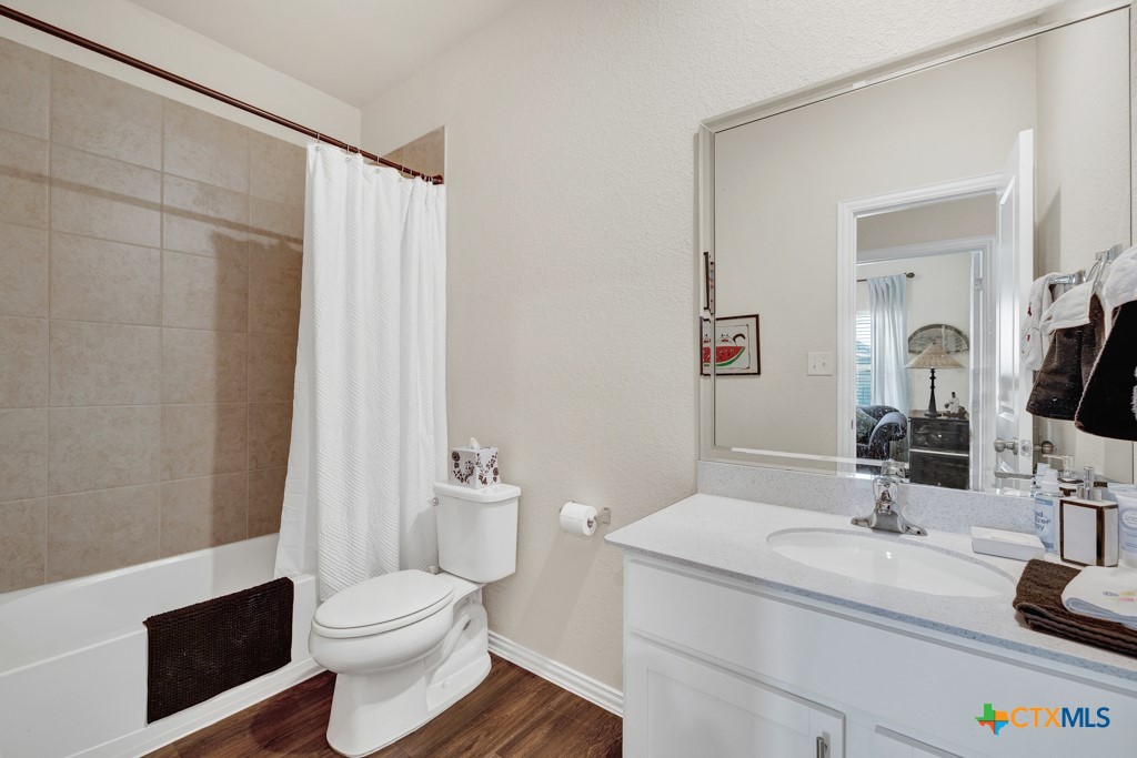 1444 Harwell Loop Kyle, TX 78640 - Photo 5 of 37 a bathroom with a sink toilet a mirror and shower