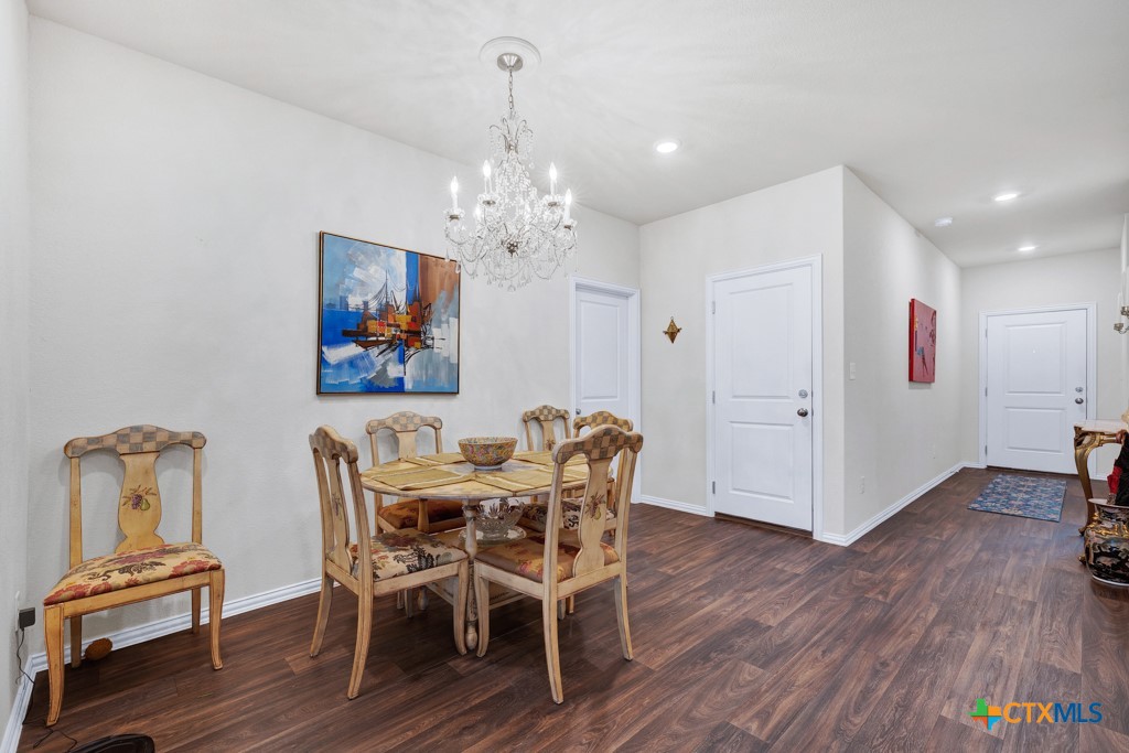 1444 Harwell Loop Kyle, TX 78640 - Photo 8 of 37 a view of a dining room with furniture and wooden floor