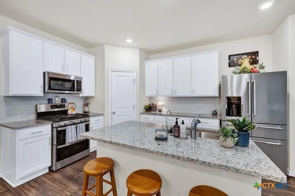 a view of kitchen island with granite countertop living room