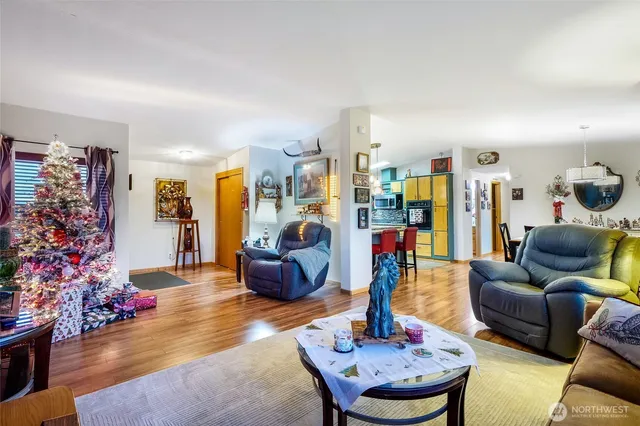 a living room with furniture and a wooden floor