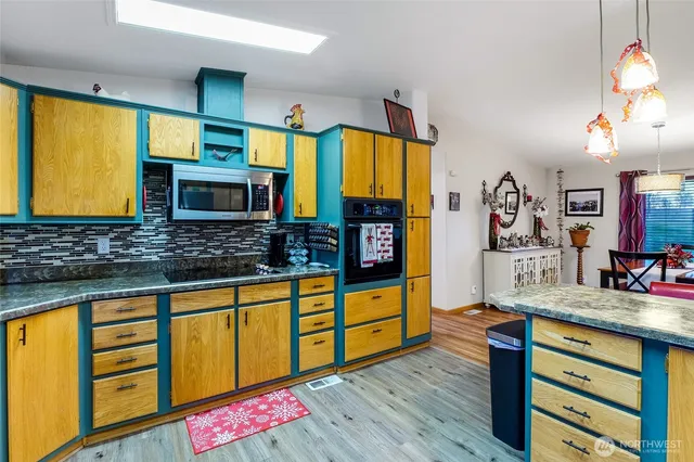 a kitchen with stainless steel appliances wooden cabinets counter space and a sink