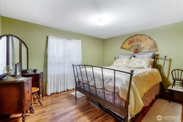 a large bed sitting in a room next to a window