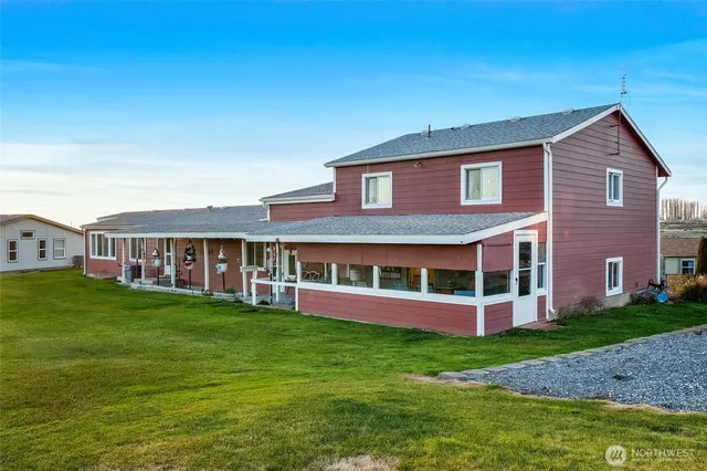 a view of a house with a yard and sitting area