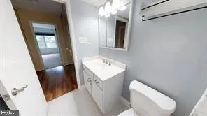 a bathroom with a sink toilet and mirror