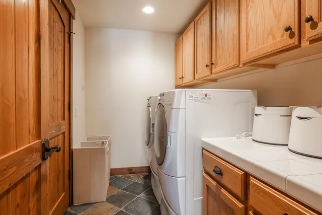 a kitchen with refrigerator and cabinets