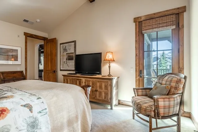 a bedroom with a bed and a television in it