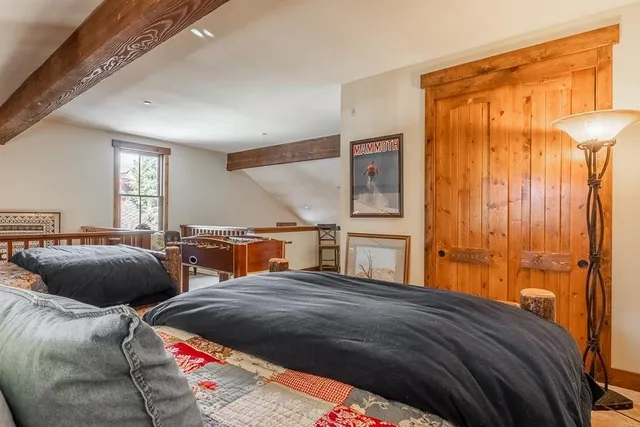 a bedroom with two beds and a chandelier