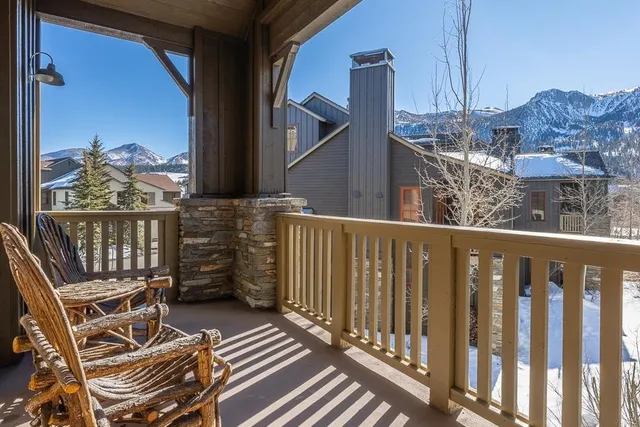 a view of a balcony with chair and iron stairs