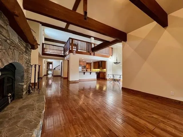 a view of a porch with wooden floor and a yard